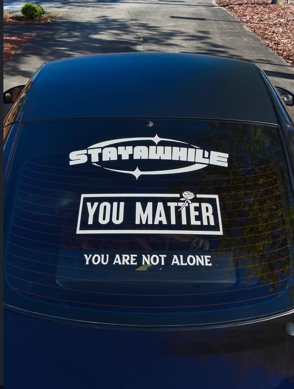 Stayawhile + You Matter stickers on car rear window