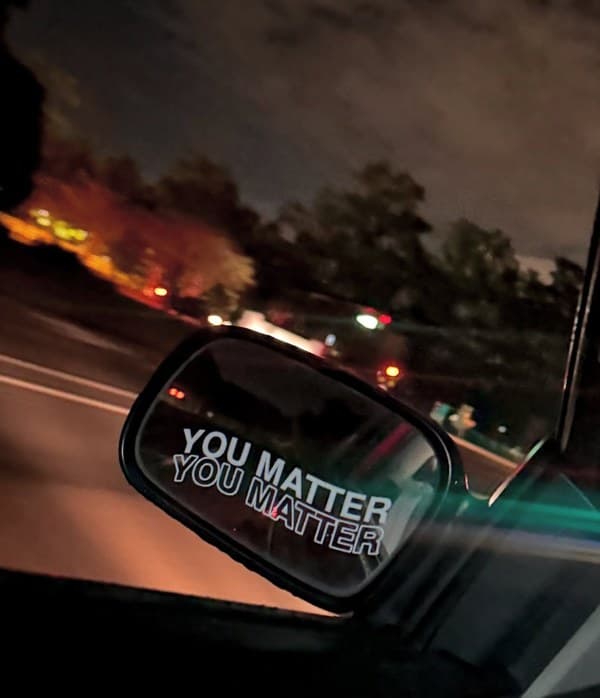 You Matter sticker reflected in side mirror at night