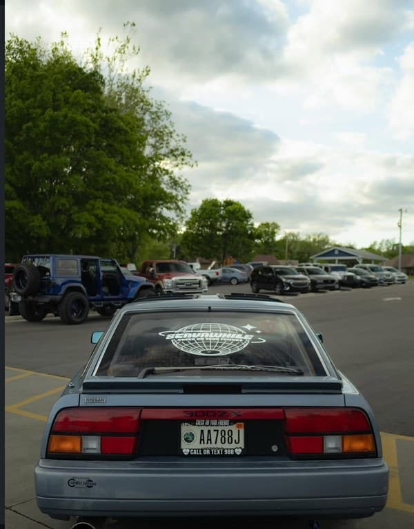 300Z in parking lot with Stayawhile globe banner