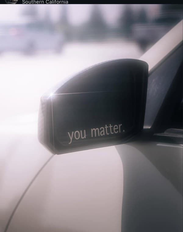 You Matter sticker on car side mirror close-up
